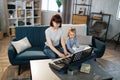 Mother teaching cute little musician girl to play piano.