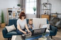 Mother teaching cute little musician girl to playing musical instruments.