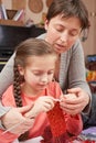 Mother teaching daughter girl knit, emotions and difficulties, handmade and handicraft concept