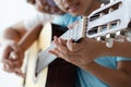 Mother teaching the daughter learning how to play acoustic classic guitar for jazz and easy listening song select focus shallow Royalty Free Stock Photo