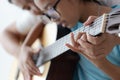 Mother teaching the daughter learning how to play acoustic classic guitar for jazz and easy listening song select focus shallow Royalty Free Stock Photo