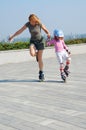 Mother teaching daughter rollerblading Royalty Free Stock Photo
