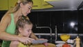 Mother teaching daughter smart girl learning to cook. Mistress children to cook a Neapolitan egg fried omelette from