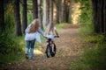 Mother teaching her daughter cycling in a forest outdoors Royalty Free Stock Photo