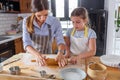 Mother making apple pie with children at home kitchen Royalty Free Stock Photo