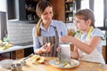 Mother making apple pie with children at home kitchen Royalty Free Stock Photo