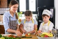 Mother Teaching Kids to Cook and Help in the Kitchen Royalty Free Stock Photo
