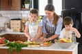 Mother Teaching Kids to Cook and Help in the Kitchen Royalty Free Stock Photo