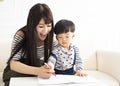 Mother teaching son draw and write at home Royalty Free Stock Photo