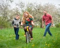 Mother teaching son to ride a bike by his example Royalty Free Stock Photo