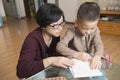 Mother teaching son writing Royalty Free Stock Photo