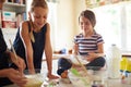 Mother, teamwork or happy kids baking in kitchen as a family with siblings learning cookies recipe at home. Girl, baker Royalty Free Stock Photo
