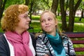 Mother and teen daughter on a park bench Royalty Free Stock Photo