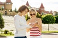 Mother and teen daughter portrait. Background summer city, mom and daughter are looking in smartphone Royalty Free Stock Photo