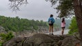 Mother and teen daughter standing on ridge on trail