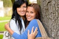 Mother and teen hugging outdoors relaxing smiling