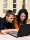 Mother and teenage boy with laptop