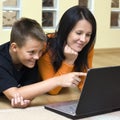 Mother and teenage boy with laptop