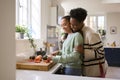 Mother With Teenage Daughter Helping To Prepare Meal At Home In Kitchen Together Royalty Free Stock Photo