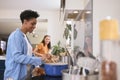 Mother With Teenage Daughter Helping To Prepare Meal At Home In Kitchen Together Royalty Free Stock Photo