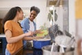 Mother With Teenage Daughter Helping To Prepare Meal At Home In Kitchen Together Royalty Free Stock Photo