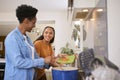 Mother With Teenage Daughter Helping To Prepare Meal At Home In Kitchen Together Royalty Free Stock Photo