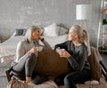 Mother With Teenage Daughter At Home Talking and drinking tea Royalty Free Stock Photo