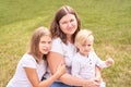 Mother with teenage daughter and little son. Outdoor family portrait. Three