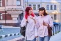 Mother and teenage daughter, walking talking together along city street Royalty Free Stock Photo