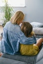 Mother with teenage girl hugging on the sofa Royalty Free Stock Photo