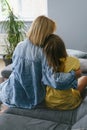 Mother with teenage girl hugging on the sofa Royalty Free Stock Photo