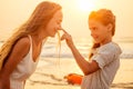 Mother and teenager daughter using sunscreen on the beach Royalty Free Stock Photo