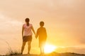 Mother and their son standing holding hands and watching sunset Royalty Free Stock Photo