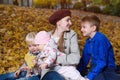 Mother and three children in autumn park. Large happy family. Siblings Royalty Free Stock Photo