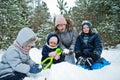 Mother with three children in winter nature. Outdoors in snow Royalty Free Stock Photo