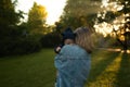 Mother throws baby up, playing and laughing in sun summer day on nature. Happy family outdoors. Royalty Free Stock Photo