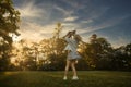 Mother throws baby up, playing and laughing in sun summer day on nature. Happy family outdoors. Royalty Free Stock Photo