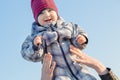 Mother throws up her baby in the sky in nature. Royalty Free Stock Photo