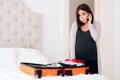 Worried Woman Preparing Hospital Bag Talking on The Phone Royalty Free Stock Photo