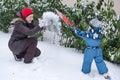 Mother and toddler boy having fun with snow on winter day Royalty Free Stock Photo