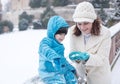 Mother and toddler boy having fun with snow on winter day Royalty Free Stock Photo