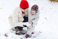 Mother and toddler boy having fun with snow on winter day Royalty Free Stock Photo