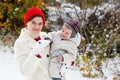 Mother and toddler boy having fun with snow on winter day Royalty Free Stock Photo