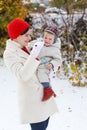 Mother and toddler boy having fun with snow on winter day Royalty Free Stock Photo