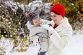 Mother and toddler boy having fun with snow on winter day Royalty Free Stock Photo