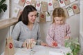 Mother, toddler child writing Christmas letter, advent calendar task Royalty Free Stock Photo