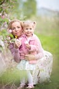 Mother and toddler daughter holding apple tree flowers in orchard Royalty Free Stock Photo