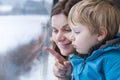 Mother and toddler son looking out train window outside Royalty Free Stock Photo