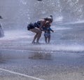 Mother and Toddler in sun hates at Play in Seattle Fountain