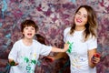 Mother together with a daughter is shown with palms soiled with